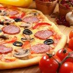 Pepperoni Pizza With Cherry And Mushrooms On The Bamboo Kitchen Table